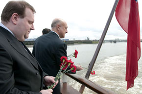Ambassador Gurbanov consigns some of the 613 carnations to the Thames, each representing a Khojaly victim