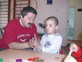 UAFA staff member with child at Shagan home for children with mental and physical disabilities - developing a child’s sensory skills