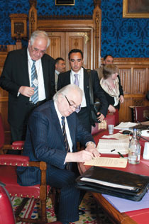 Lord Laird signs the declaration affirming the role of religion in conflict resolution
