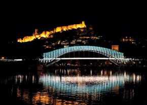 Footbridge over Mikhvera River in Tbilisi with Nar castle in Background