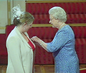 The Queen presents UAFA founder Gwendolyn Burchell with an MBE on 23 June 2004 