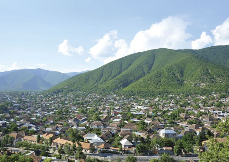 A view over the upper part of the city and surrounding Caucasus Mountains
