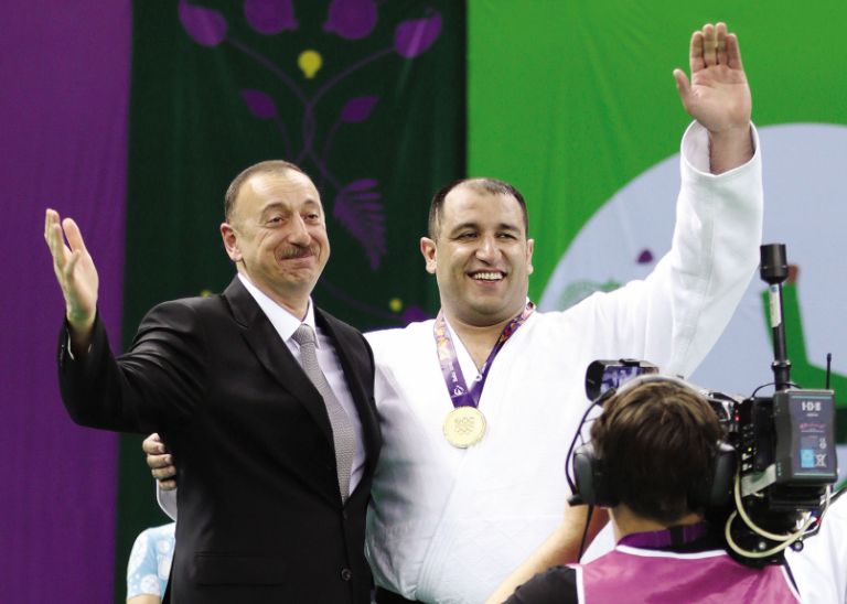 Being presented his European Games gold medal by President Ilham Aliyev