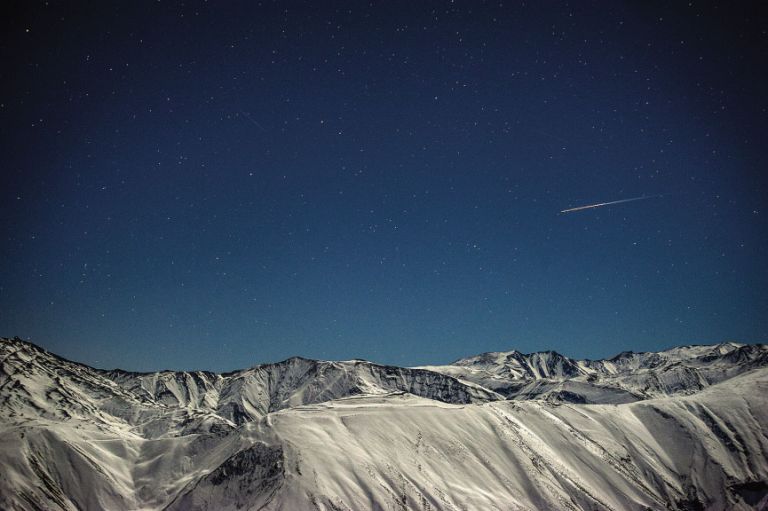 A shooting star flies over the Greater Caucasus Mountains, seen from Qaleykhudat village